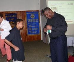 Super Bowl champion Roland Williams autographs the shoe of Kingshill School ninth-grader Emile Brin during Wednesday's Rotary Mid-Isle meeting. Super Bowl champion Roland Williams autographs the shoe of Kingshill School ninth-grader Emile Brin during Wednesday's Rotary Mid-Isle meeting.